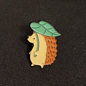 Cute Hedgehog Under a Leaf Enamel Pin or Magnet - Gimme Shelter